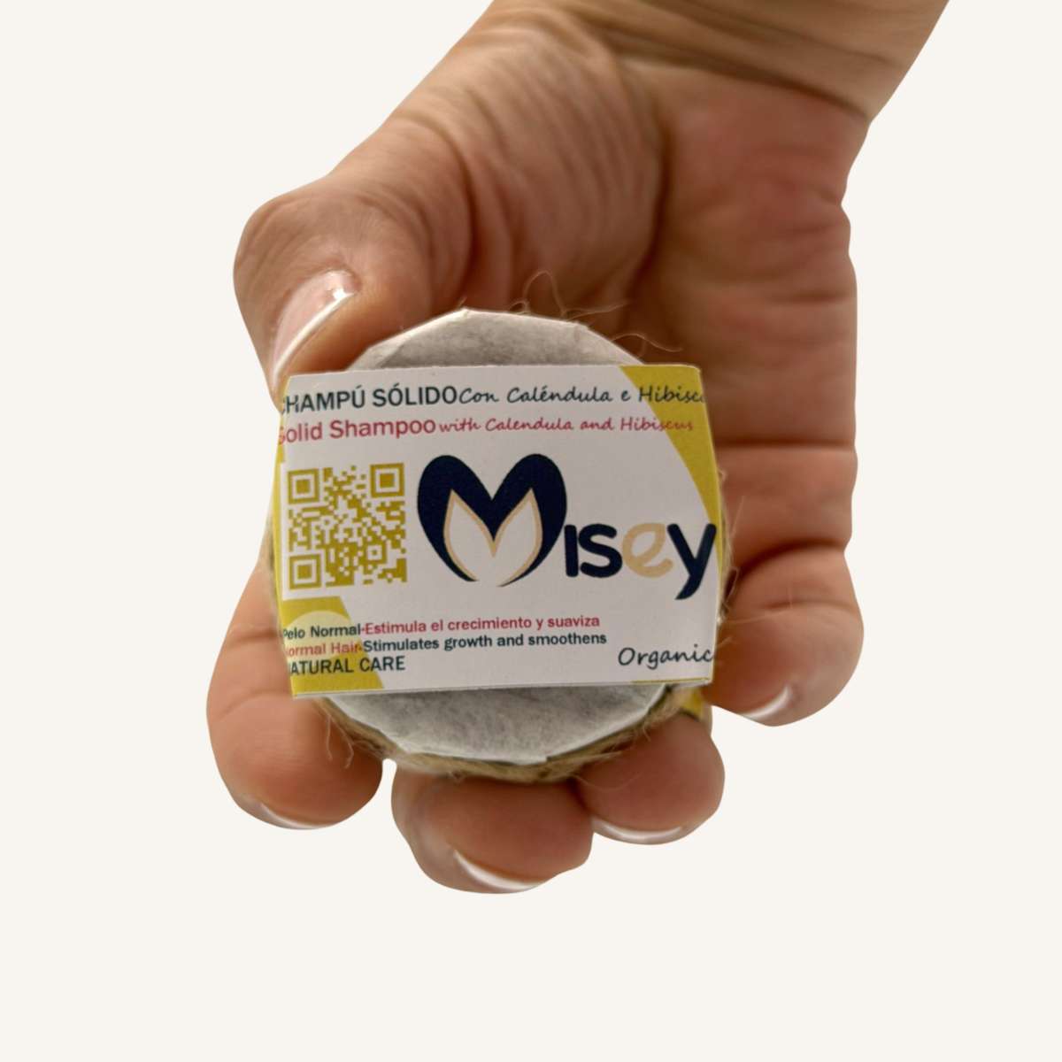 Envase sostenible y etiqueta del champú sólido de caléndula Misey.